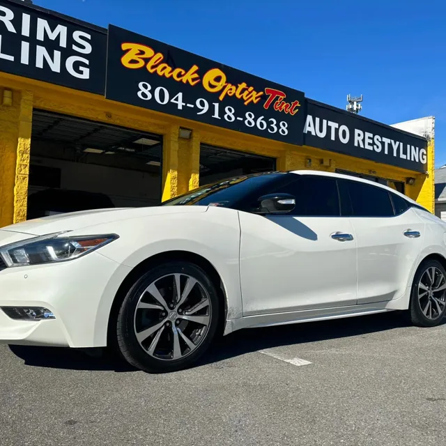 White Nissan Maxima with new window tint at the North Richmond shop